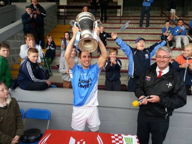 Newtown Blues' Stephen Moonan lifts the Joe Ward Cup after his side's victory over Cooley Kickhams in last year's senior final