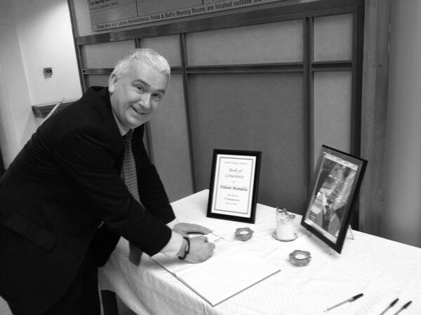 Cllr Declan Breathnach signing the book of condolence for Nelson Mandela at County Hall