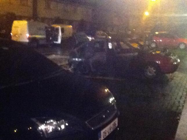 The scene at Belfry Drive on Friday night, with one of the burnt out cars